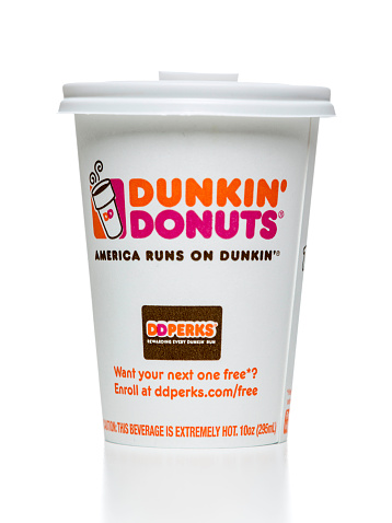 Miami, USA - September 26, 2014: White Dunkin' Donuts hot coffee cup with plastic cap.