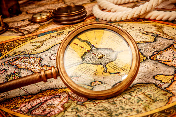 istock Vintage magnifying glass lies on an ancient world map 527479793
