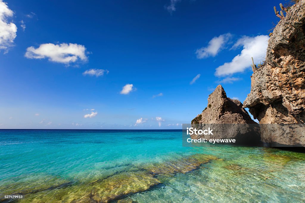 Rocky coast and turquoise waters at Curacao beach Rocks and clear turquoise water at Cas Abao beach, Curacao Beach Stock Photo