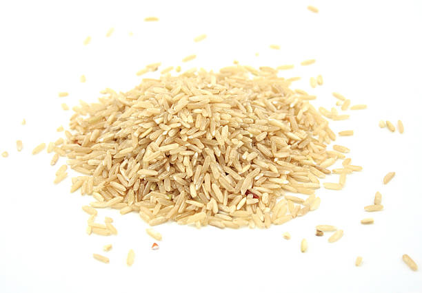 istock pile of brown rice isolated on white 527482347