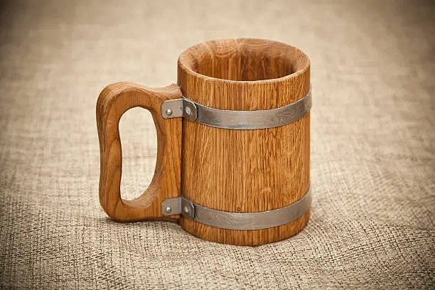 Large wooden mug on sacking 