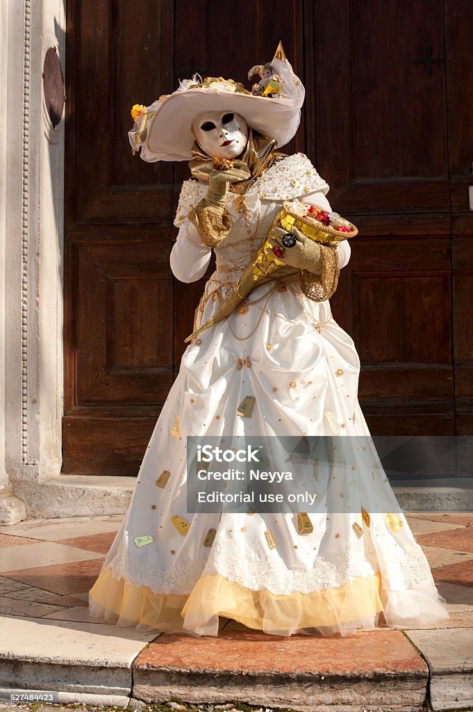 Venice Carnival 2012 Venice, Italy - February 21, 2012: The photo was taken during the famous Venice carnival on Campo San Zaccaria. We can see attractive masked person who wearing beige carnival costume and holding umbrella. Venice, Italy. 2012 Stock Photo