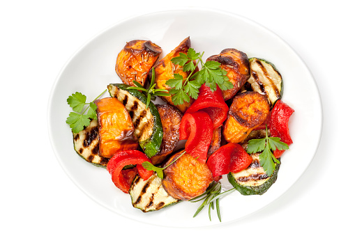 Vegetable salad with grilled red capsicum, sweet potato, zucchini and parsley.