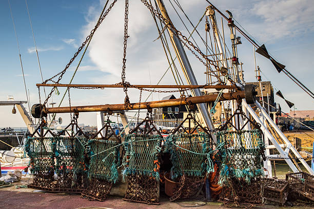 istock Scallop dredge hanging in a harbour 527493785