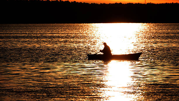 istock Boat at sunset on a lake 527495449