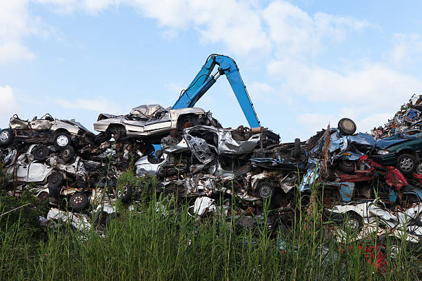 istock Scrap yard with crushed cars and blue sky 527495547