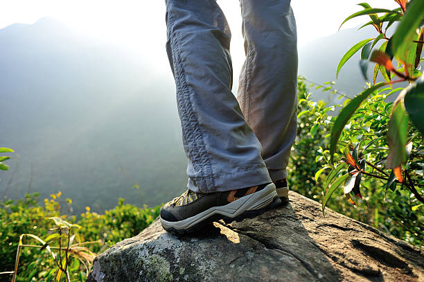 istock hiking legs  mountain peak rock 527495645