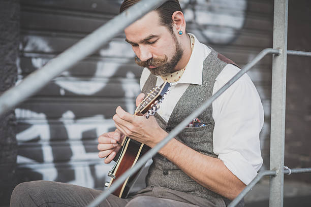 istock handsome big moustache hipster man playing mandolin 527511859