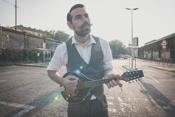 istock handsome big moustache hipster man playing mandolin 527512673