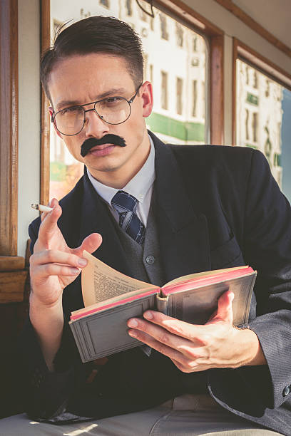 istock man with glasses and whiskers  in suit sitting 527514965