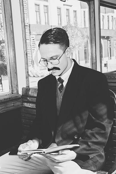 istock man with glasses and whiskers  in suit sitting 527515089