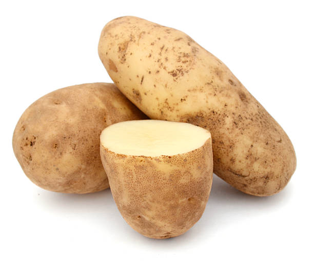 cutting and whole potatoes isolated stock photo