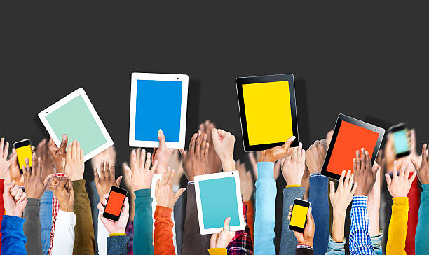 istock Group of Hands Holding Digital Devices with Copy Space 527517237