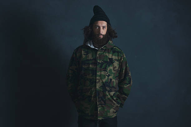 istock Vintage man with beard and long hair wearing camouflage jacket. 527520888