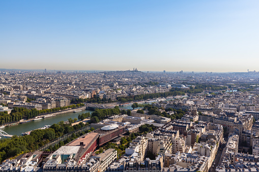 Cityscape of Paris with aerial view from Eiffel tower - the Seine river and residential buildings in morning sunshine