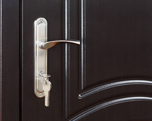istock Closed dark brown wooden door handle with lock 527521476