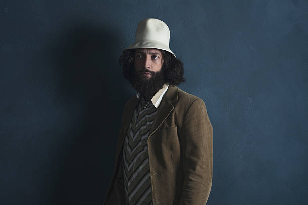 ретро человек с бородой в коричневый жакет и белая шляпа. - fashion men 1970s style hippie стоковые фото и изображения