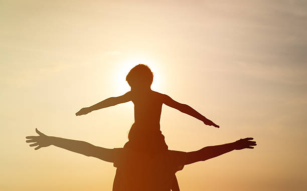 istock father and son having fun at sunset 527521800