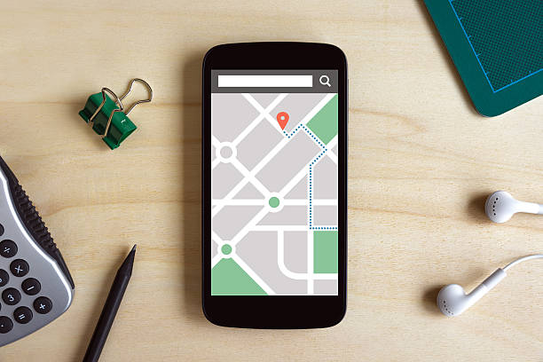 istock Map gps navigation application on phone screen on wooden desk 527523004