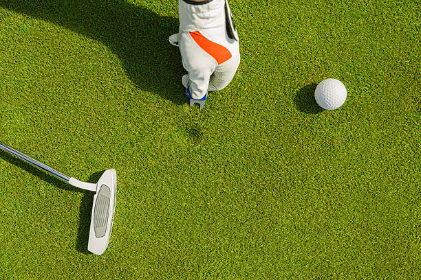 istock Marking golf ball position at the green. Focus on marker. 527523316