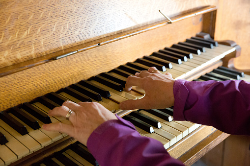 Hands playing on an old vintage church organ