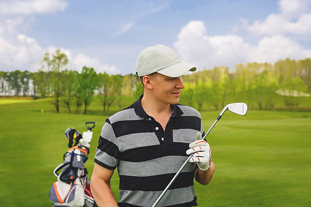 istock male golfer standing at fairway on golf course 527523890
