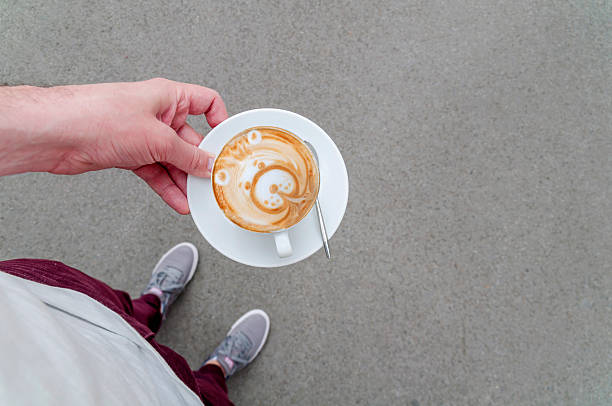 istock Top view of man holding coffee with milk 527526286