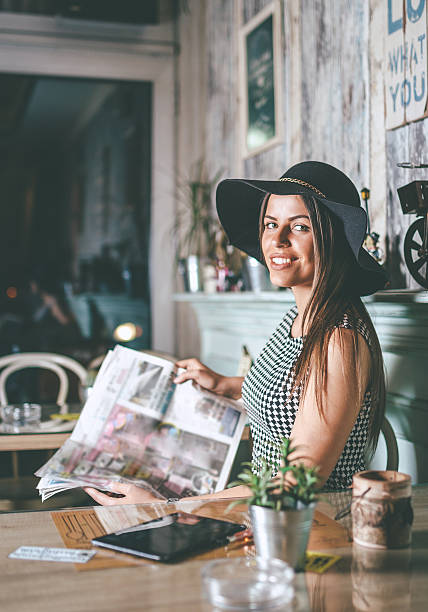 istock pretty woman reading newspaper 527530402