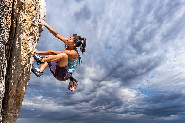 istock Rock climber clinging to a cliff. 527531506