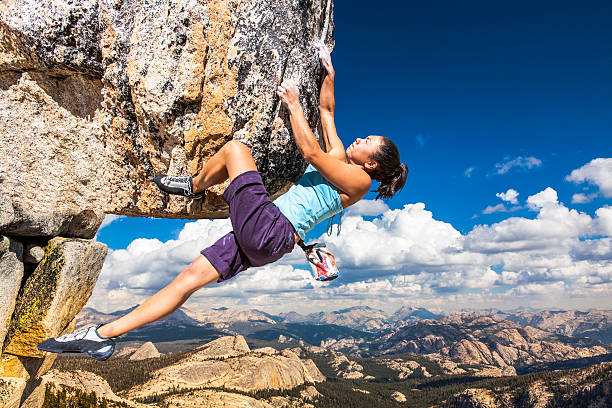 Rock climber clinging to a cliff. stock photo