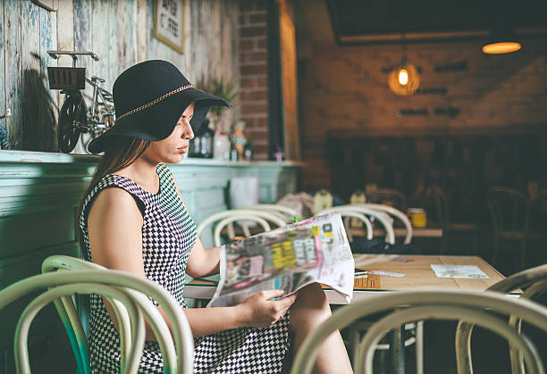 istock happy woman reading the newspaper 527532052