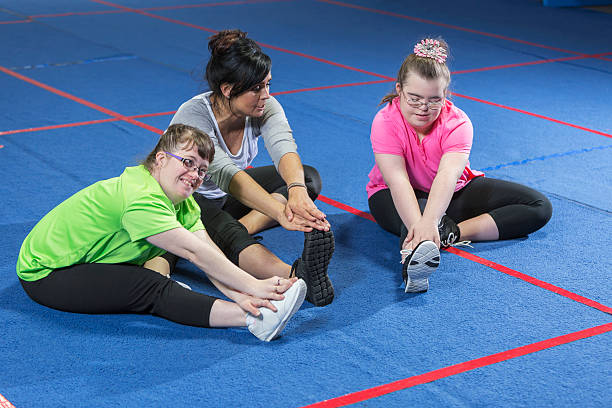 istock Fitness instructor working with special needs girls 527533850