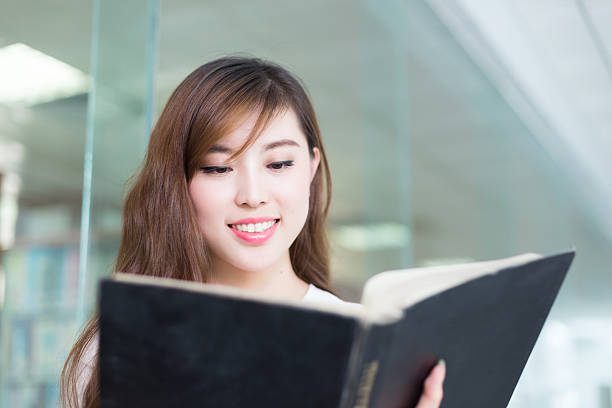 istock young beautiful asian girl student in library 527535422
