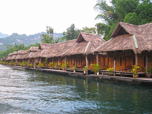 istock huts on the banks of the river 527537496