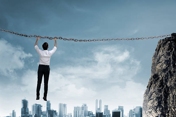 istock Asian business person hanging on chain 527538700