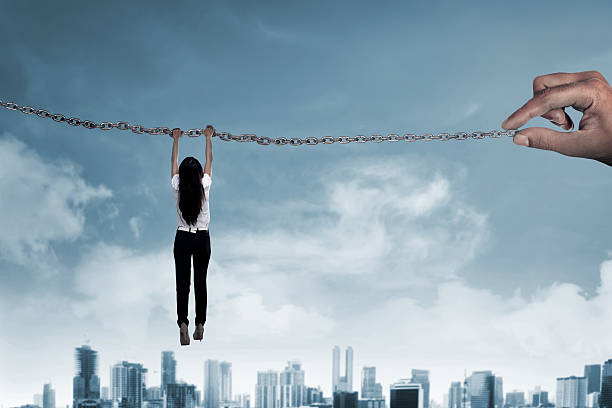 istock Asian business person hanging on chain 527538746