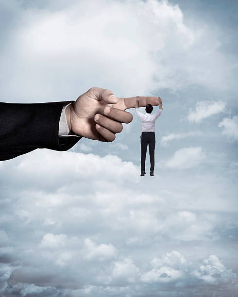 istock Asian business man hang on large finger 527539630