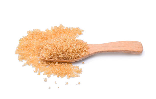 istock brown sugar in a wooden spoon isolated on white background 527541412