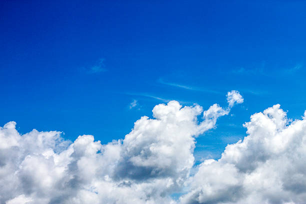 istock white fluffy clouds in the blue sky 527542352
