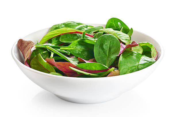 Bowl with fresh green salad isolated on white background.