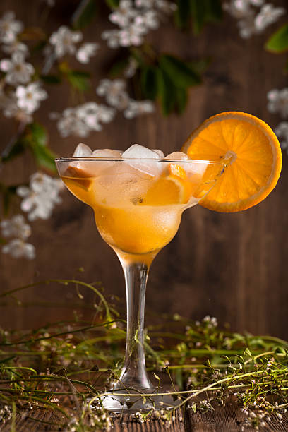 istock orange fruit soft drink cocktail with ice on a wooden 527544414
