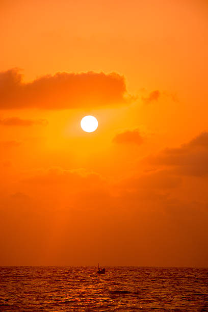 Fishing Boat On Sea At Sunset