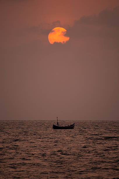 Fishing Boat On Sea At Sunset