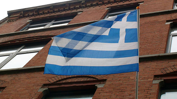 istock Flag Of Greece Against Building 527546774