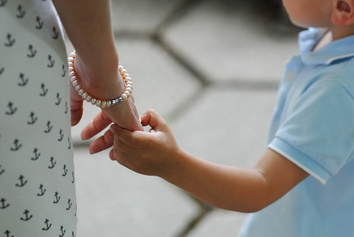 little boy gently took her mothers hand