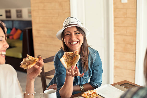 istock female friends sharing a pizza 527548342