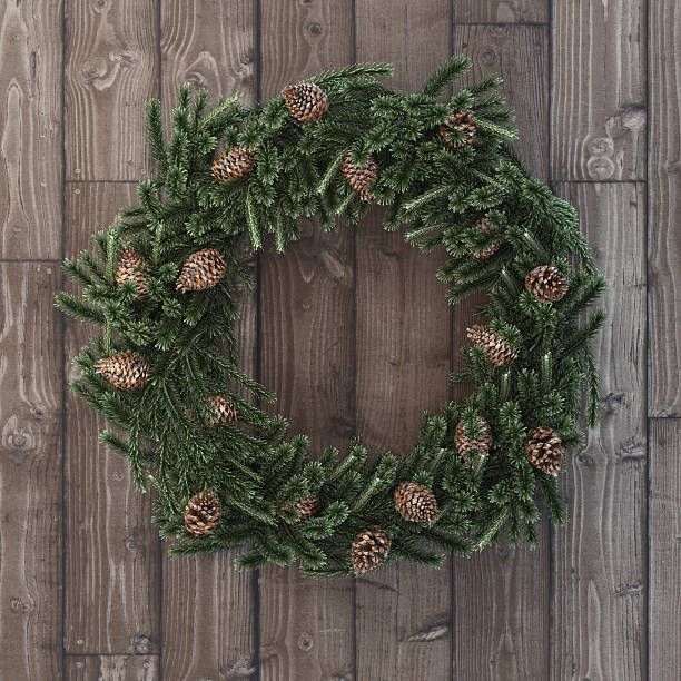 istock Christmas decorative wreath with cones on wood 527552101