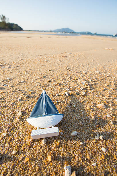 istock Sail Ship Toy Model in the Beach Sand 527552244