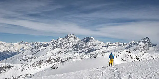 Freerider Guide in the Schwartztor Glacier; in background the highest peaks of Monte Rosa (4664 mt). Zermatt, Swiss, Europe. Exploring and adventure concept, copy space.