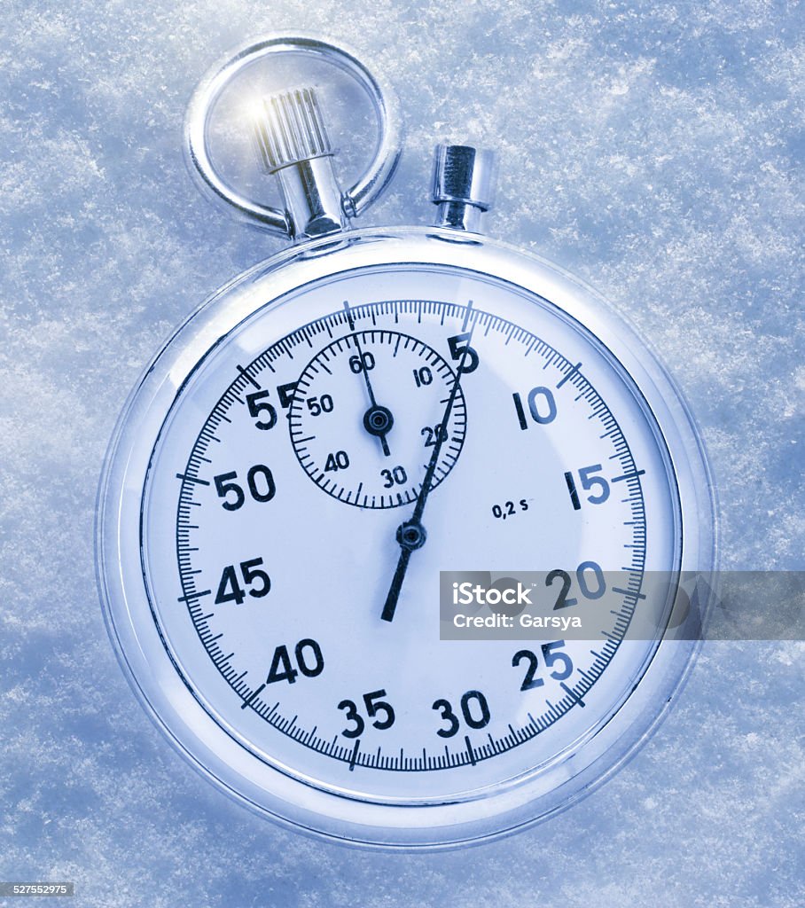 Stopwatch on snow Stopwatch on snow in blue toning Accuracy Stock Photo